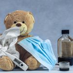 brown bear plush toy on blue textile
