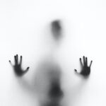 person behind fog glass