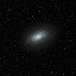 a very bright blue object in the middle of a dark sky