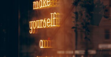 A neon sign that says make yourself on priority