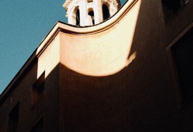 The building has a church tower in the background.