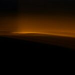 Clouds illuminated by a golden light glow.
