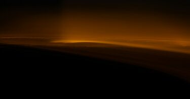 Clouds illuminated by a golden light glow.