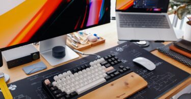 A modern desk setup with a keyboard and monitor.